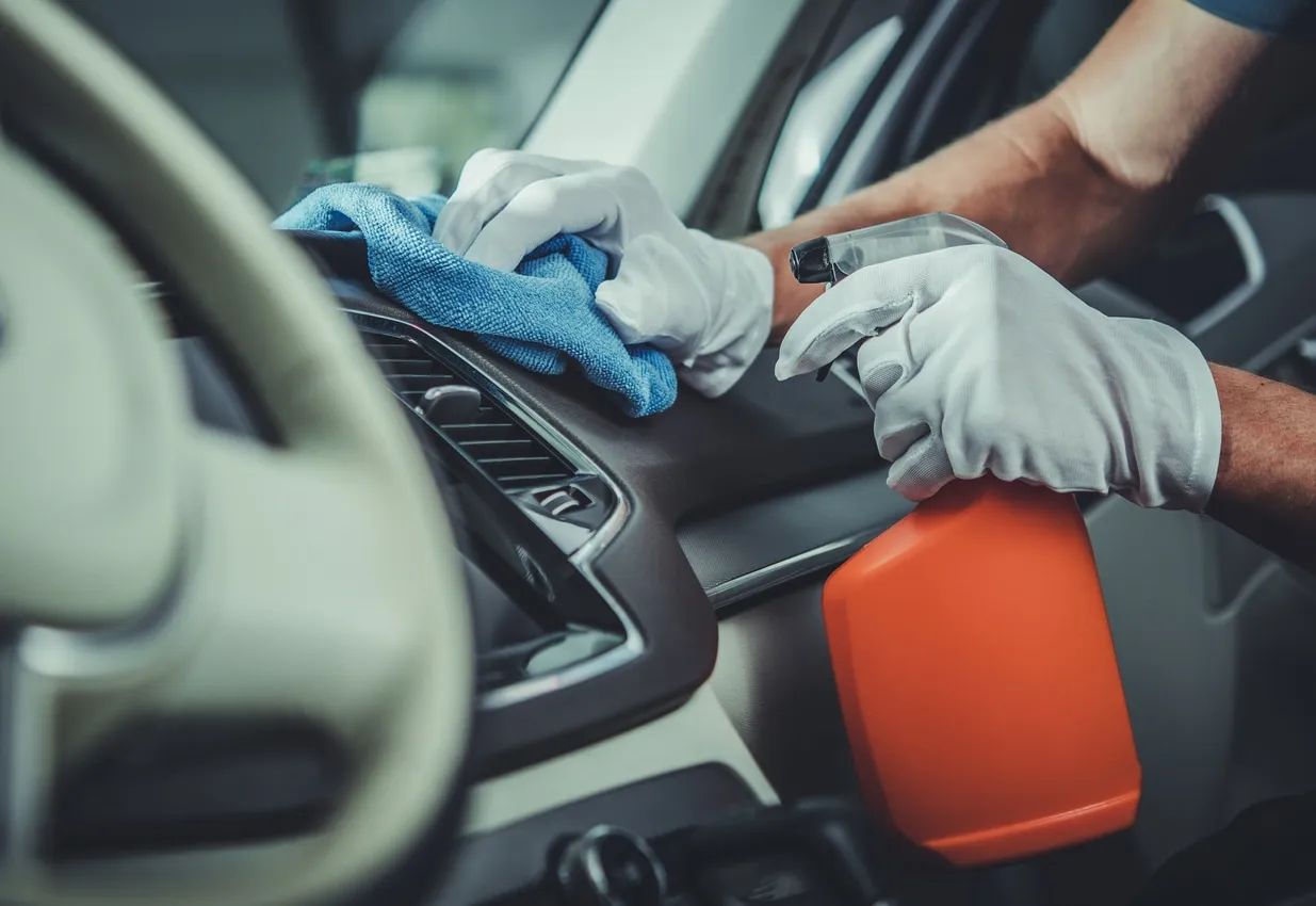 Cleaning a dashboard during an interior detail