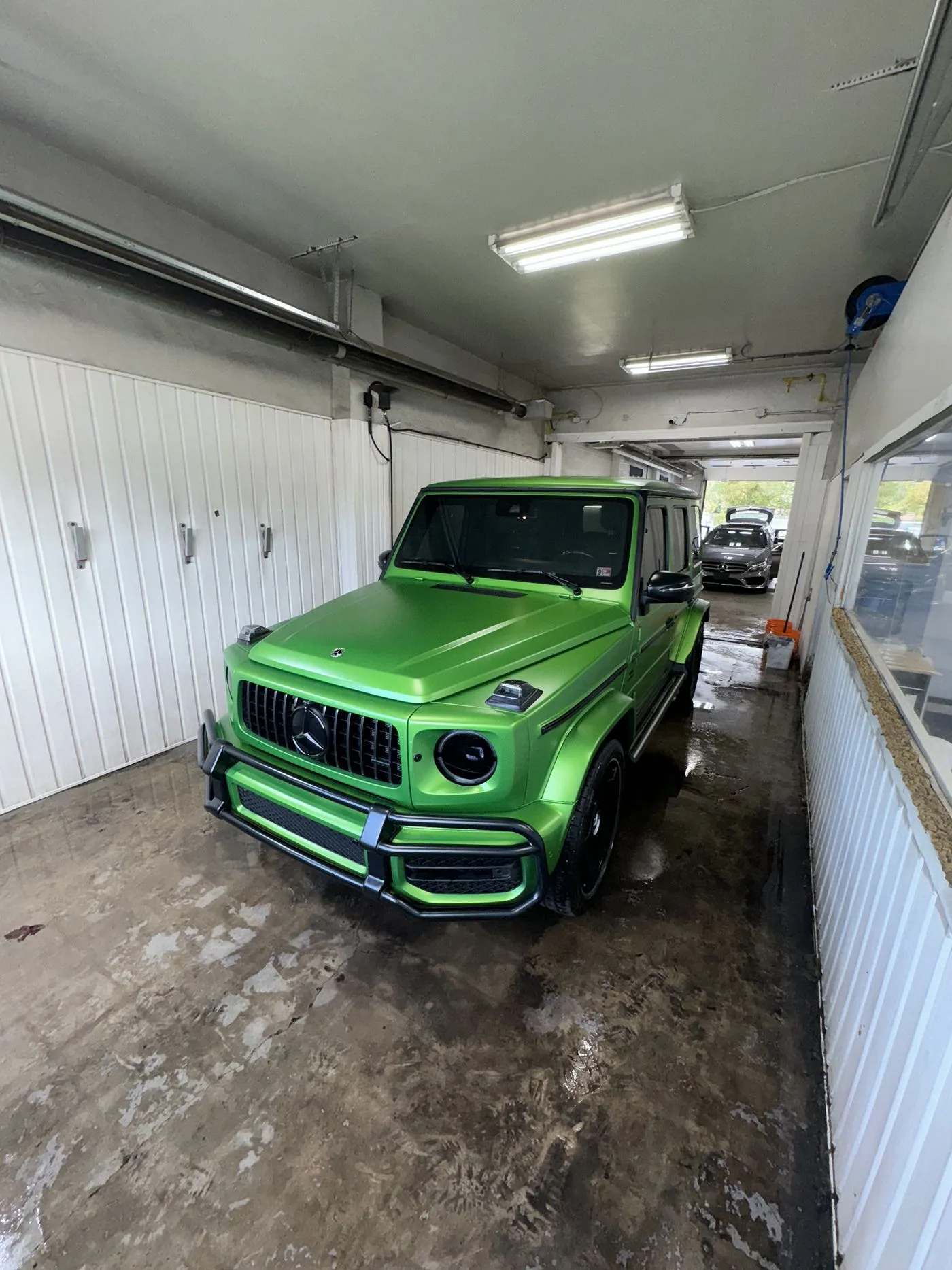 Green Mercedes G-Wagon in the wash bay